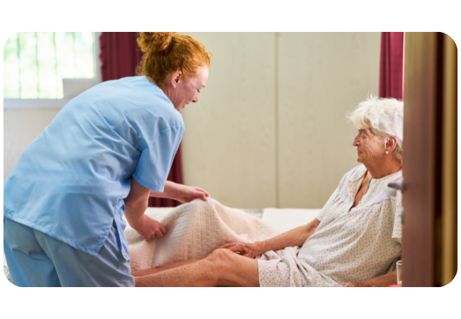 Image of a caring nurse assisting a patient in getting out of bed.